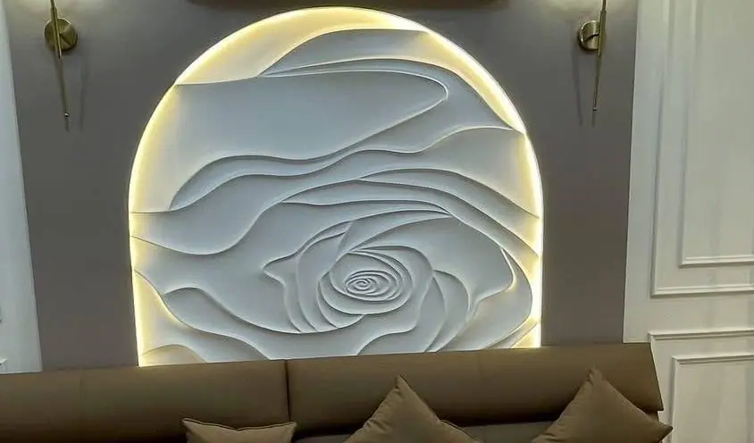 Close view of a backlit sculpted arch panel between two wall lights
